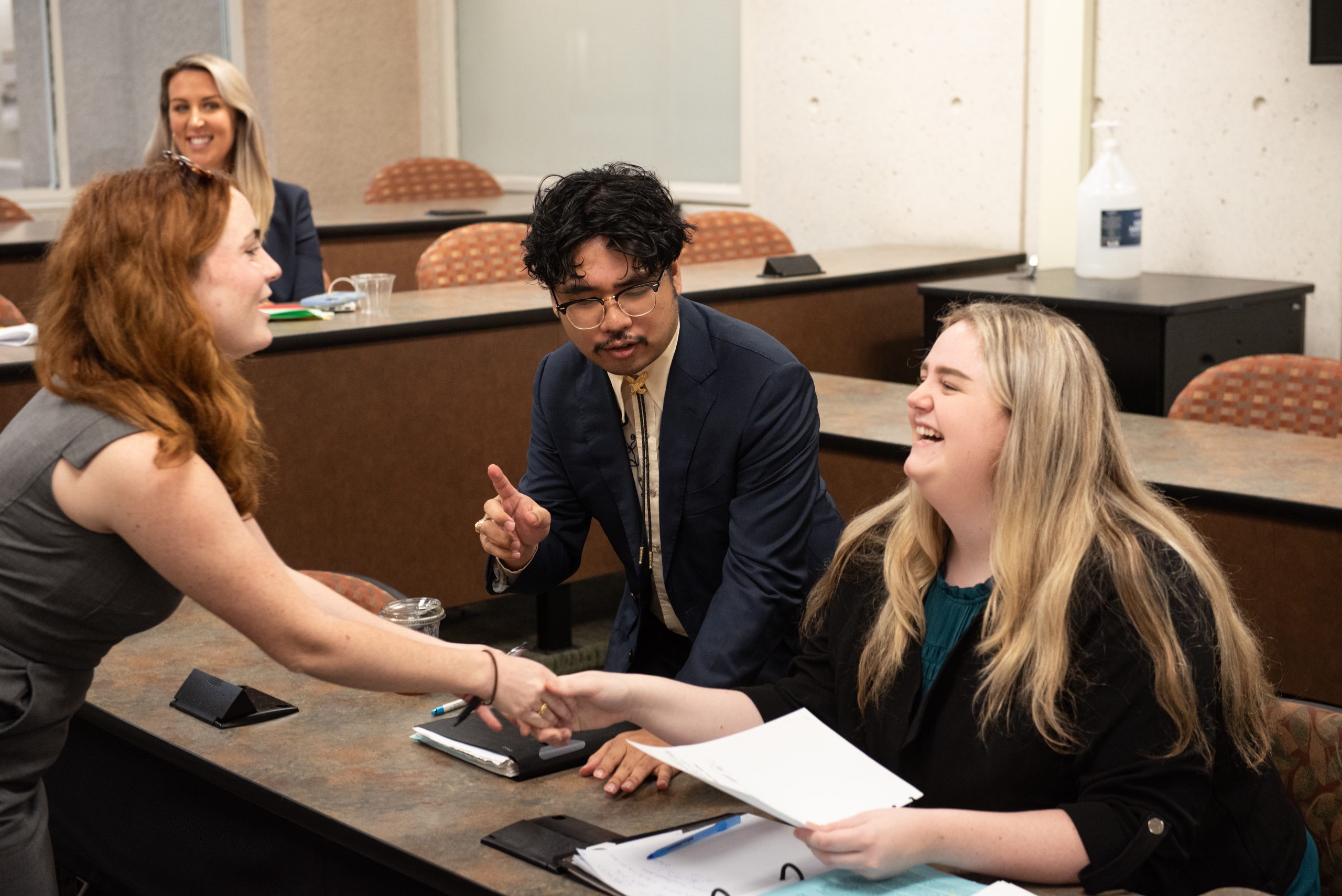 Three law students discussing a contract